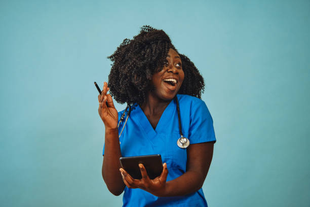 istock Nurse practitioner doctor with tablet and stethoscope laughing 1308844947