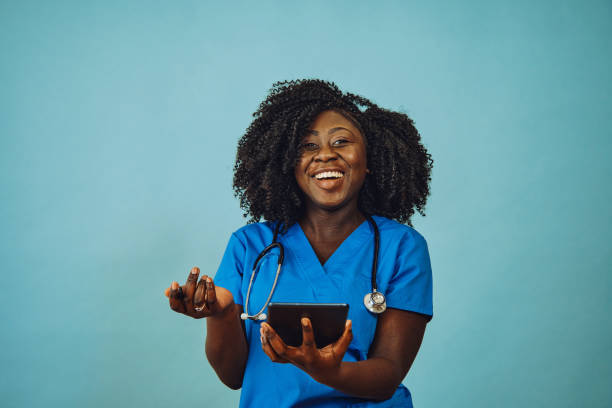 istock Nurse practitioner doctor with tablet and stethoscope laughing 1308844957