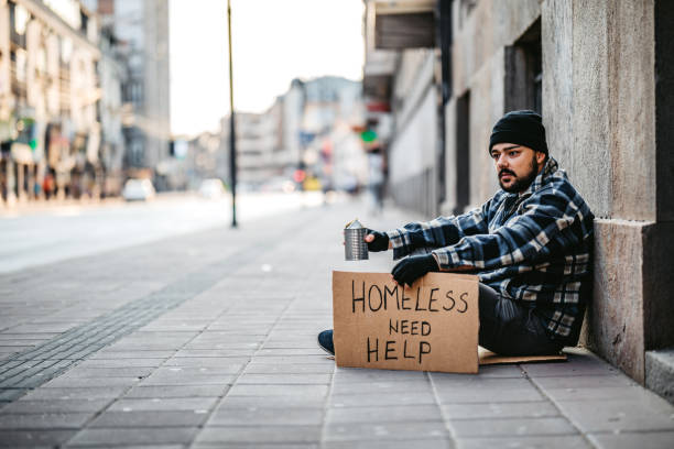 istock Homeless man sitting and begging for help 1308847335