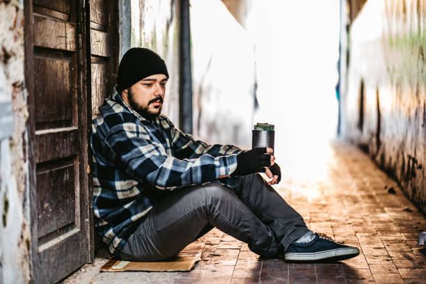 istock Homeless man sitting and begging for help 1308848213