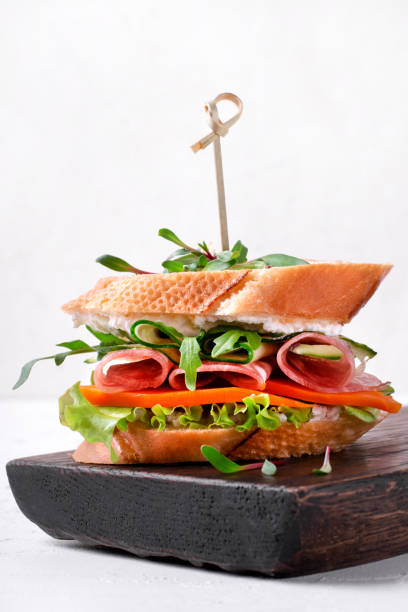 istock Sandwich with smoked sausage,cheese, vegetables and microgreen 1308848572