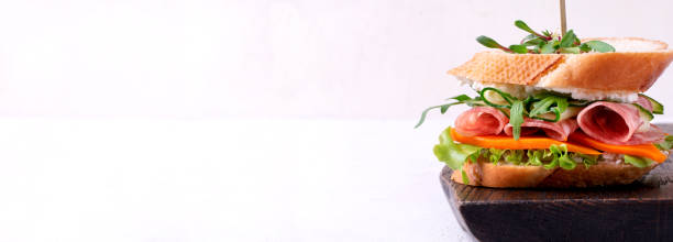 istock Sandwich with smoked sausage. Web banner 1308848582