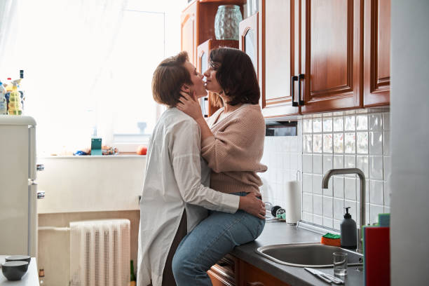 istock retty woman sitting at the table and hugging her girlfriend 1308848716