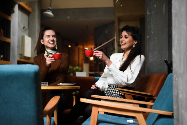 istock Two cheerful women having fun during coffee time in a cafe 1308849668