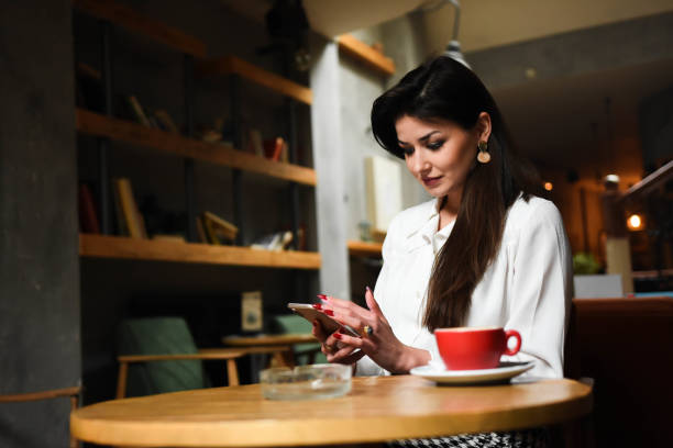 istock Young businesswoman on coffee break 1308849733