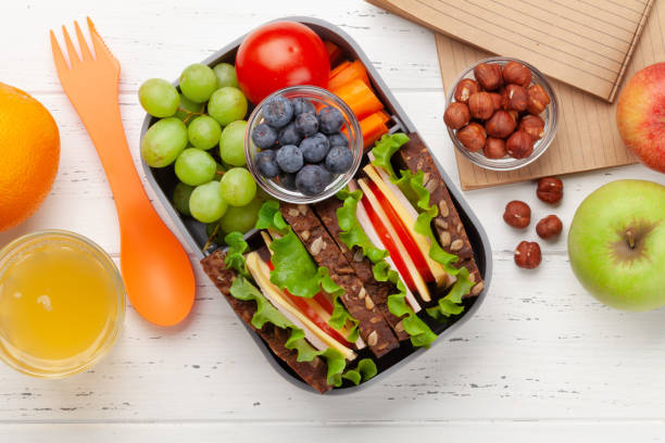 istock Healthy school lunch box with sandwich and fresh vegetables 1308851140
