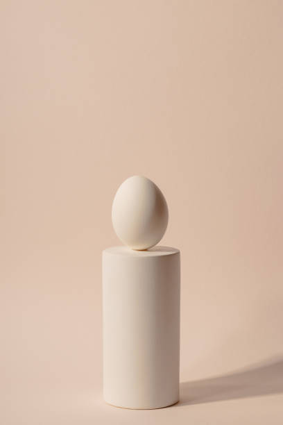 istock One white Easter egg on a podium against a neutral background. Minimalism and simplicity aesthetics 1308854551