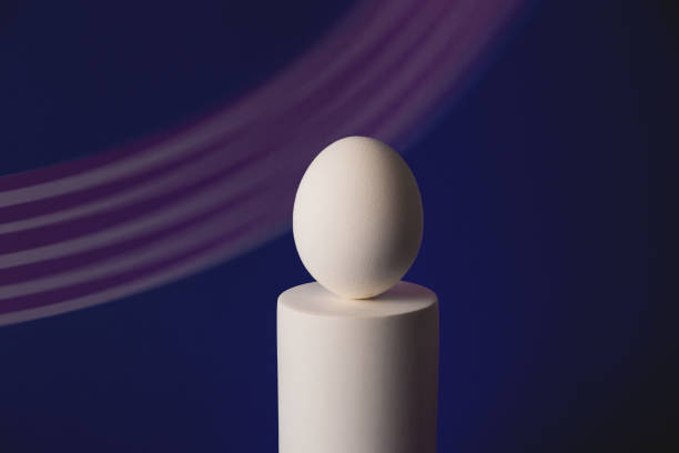 istock White easter egg on podium in neon and purple light 1308854564