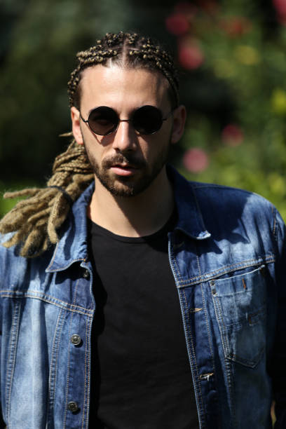 istock Attractive, young blonde bearded male model with combination of braids and dreadlocks posing in the wild. 1308858708