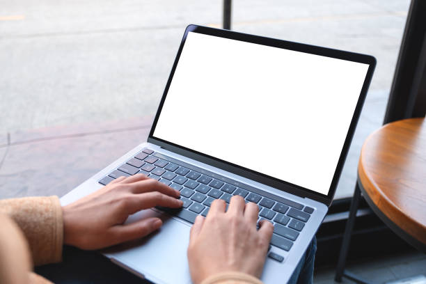 istock a woman using and typing on laptop computer with blank white desktop screen 1308858956