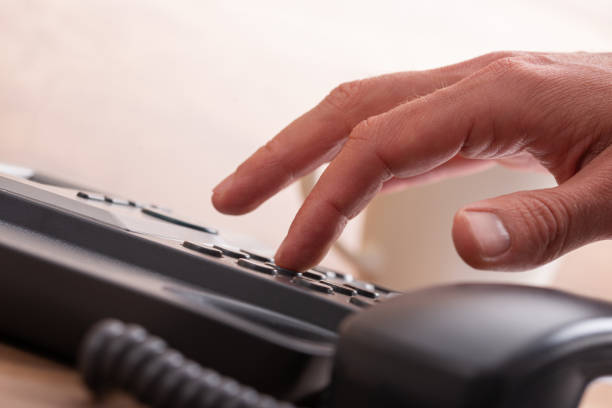 istock Male finger dialing a telephone number 1308868735