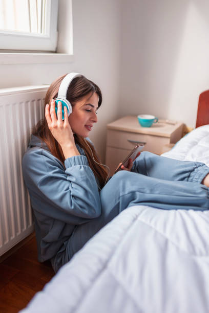 istock Woman listening to audio book 1308870667