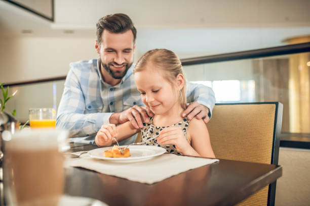 istock Young father having a breakfast with his daughter 1308870851