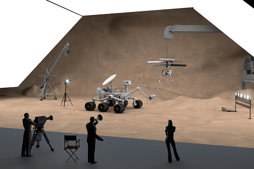 Mars explorer rover and drone helicopter in fake Mars Studio. First vehicle to fly on another planet after Rover vehicles, is this true?.. Conspiracy theorists talk about never going to Mars. Science team doing tests and shots in the studio.
