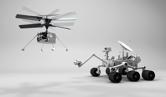 Mars explorer rover and drone helicopter on white background for new researches. First vehicle to fly on another planet after Rover vehicles.