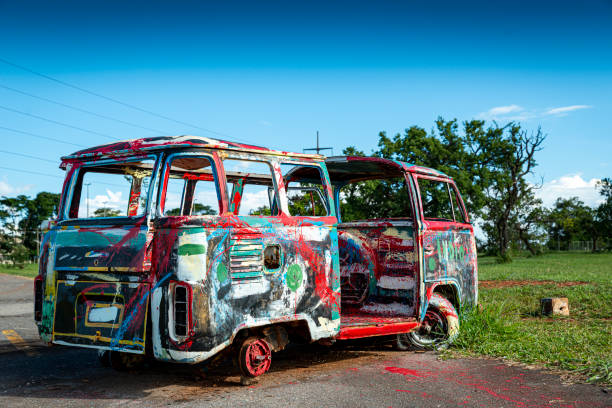 Expression contemporary and modern art of colourful wrecks of volkswagen T2 combi freely exposed under the bright sky of Brasilia