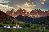 Santa Magdalena in Val di Funes with Odle dolomitic group on background at sunset. South Tyrol in Italy.