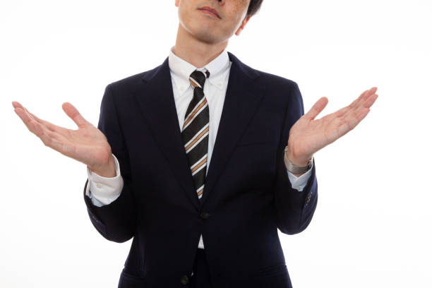 A business person who makes a stunning gesture A business person who makes a stunning gesture, white background asian suit man cross hand stock pictures, royalty-free photos & images