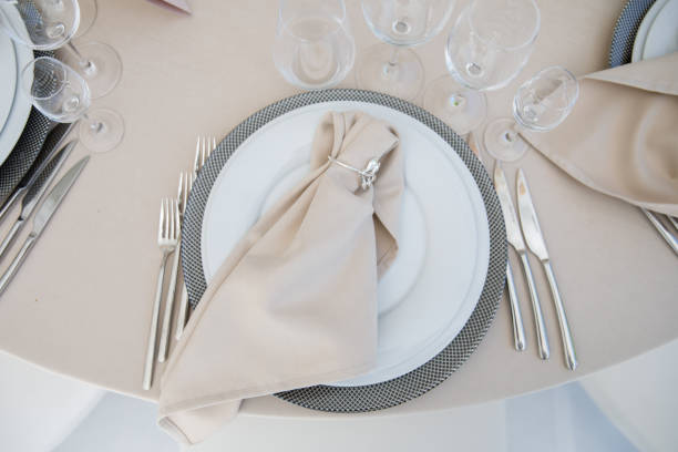 istock Festive wedding table setting with flowers, napkins, cutlery, glasses, bright summer table decor. Wedding decor 1308878078
