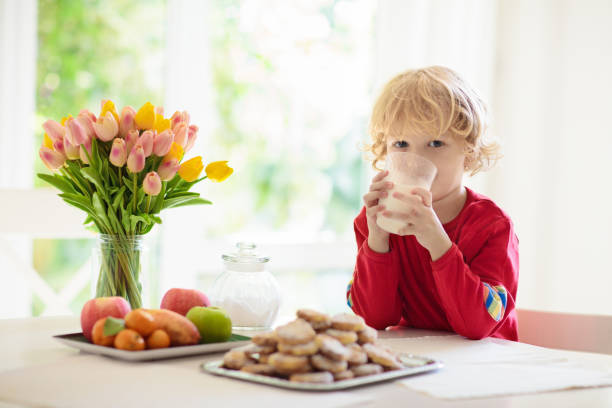istock Child eating breakfast. Kid drinking milk. 1308882066