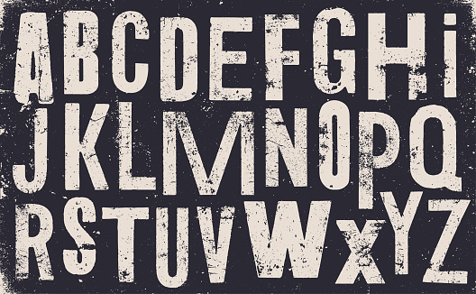 Vector distressed old uppercase alphabet. White letters on black weathered texture background. Grunge and weathered capital letters.