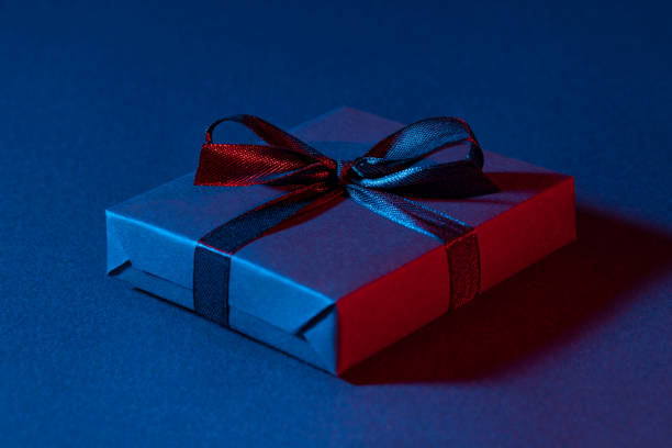 istock Blue red gift box close up on colorful background 1308883902