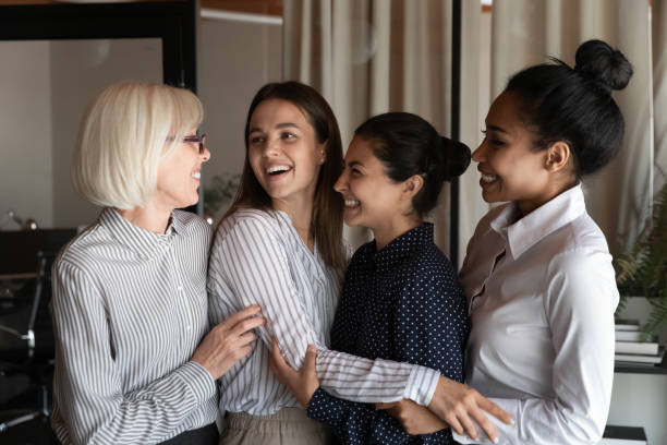 istock Smiling multiracial female colleagues chat at office meeting 1308883976