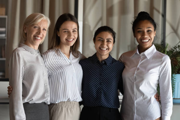 istock Smiling multiracial female colleagues pose in office 1308883978
