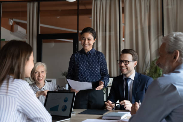 istock Smiling diverse employees discuss ideas at team meeting 1308884021