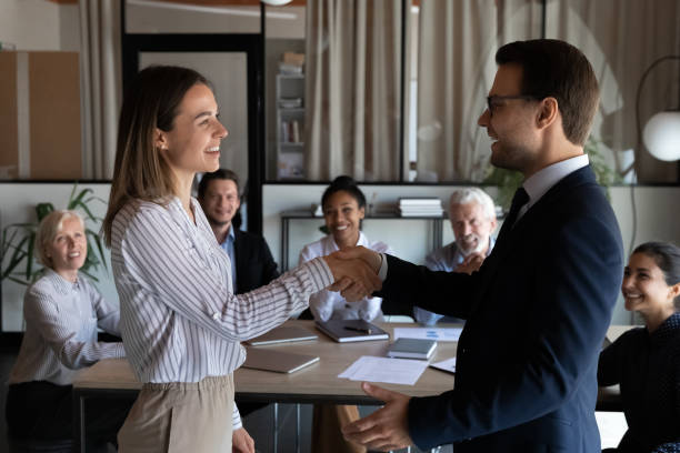 istock Happy diverse employees handshake at office meeting 1308884023