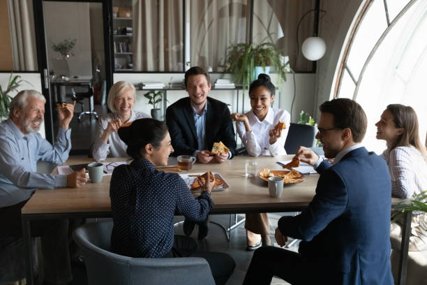 happy multiethnic colleagues have fun lunching together - pizza eating african descent lunch imagens e fotografias de stock