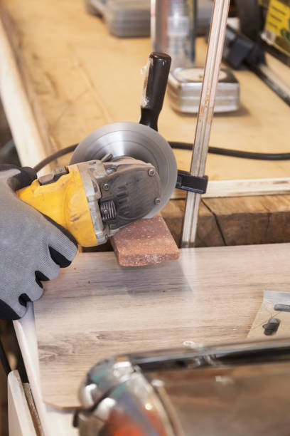 istock grinder worker cuts a stone the electric tool worker is tiling at home, brick 1308884070