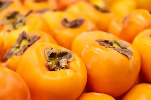 Ripe orange Persimmon in Grocery store. Close-up, selective focus