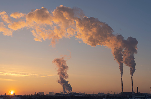 Environmental pollution. Global warming. Climate change. Dirty energy. Factory chimneys emit harmful substances into air