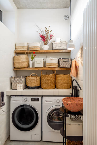 istock Home laundry with machines and clothes baskets 1308888491