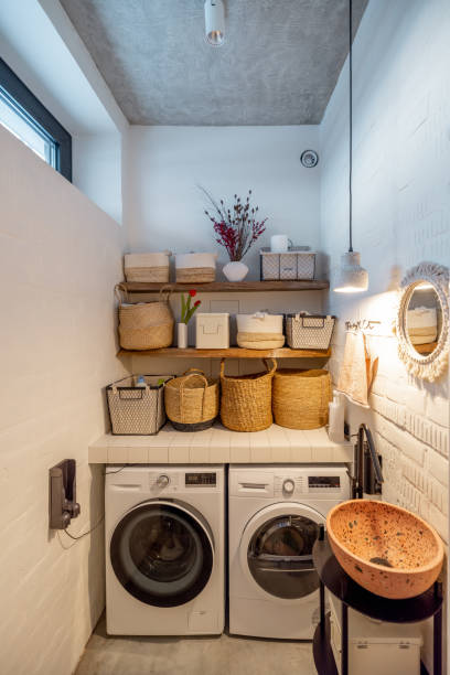 istock Home laundry with machines and clothes baskets 1308888518