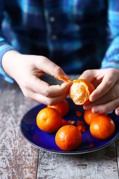 istock A man peels tangerines. 1308890790