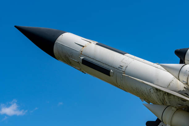 istock Old missile or rocket pointing at the blue sky 1308890973