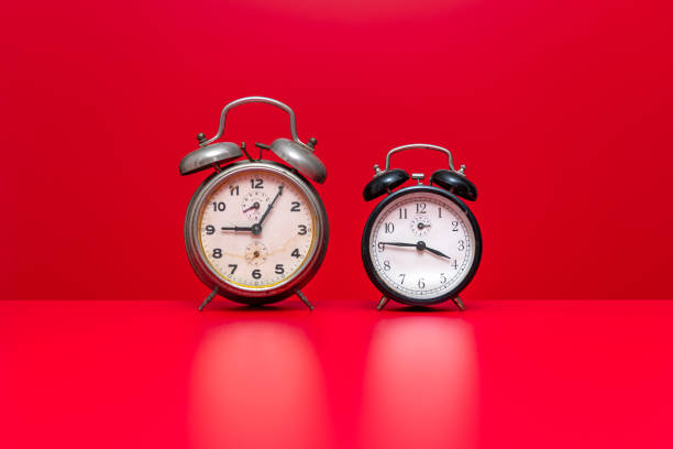 Vintage alarm clocks on red