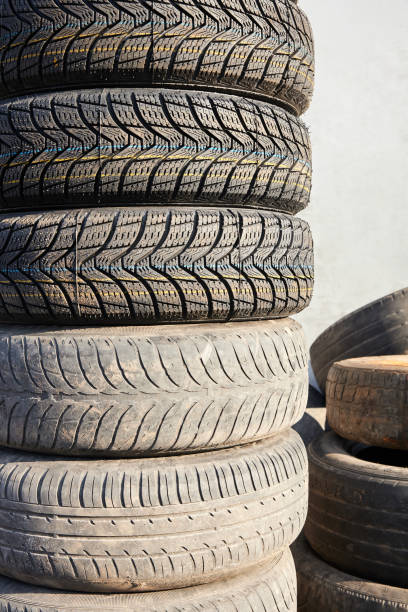 istock Stack of new and used car tires during wheel replacement 1308894492