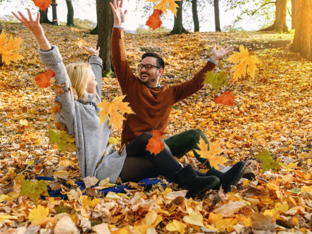 istock Couple throwing leaves 1308898346