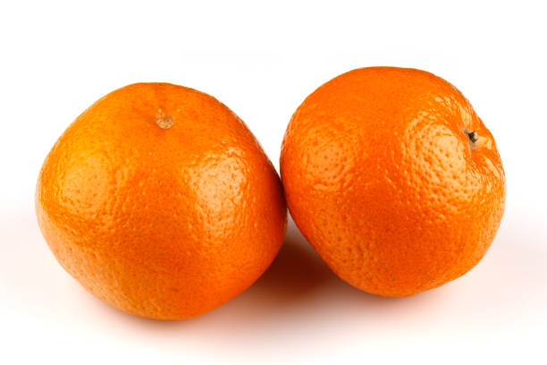 istock Whole unpeeled useful fruit tangerine close-up on a white background 1308898778