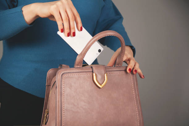 istock woman hand phone with bag pocket 1308898906