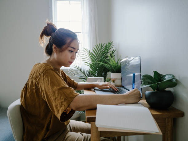 istock Asian female working at home. 1308899372