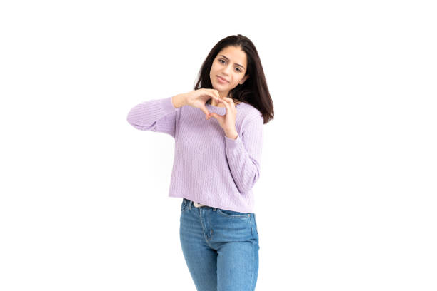 istock Latin woman making heart shape with her hands on white background 1308900961