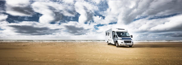 istock Motorhome on a sandy beach by the sea 1308901128