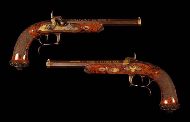 Dueling pistol France XIX century Dueling pistol France XIX cent. (1820s) on black background dueling stock pictures, royalty-free photos & images