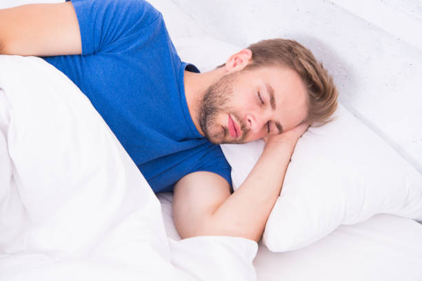 istock Tips sleeping better. Man handsome guy sleeping. Get enough amount of sleep every night. Bearded man sleeping face relaxing. Maintaining consistent circadian rhythm is essential for general health 1308905996