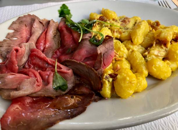 istock Medium rare roasted beef, capaccio style, with gnocchi in mustard sauce 1308906737
