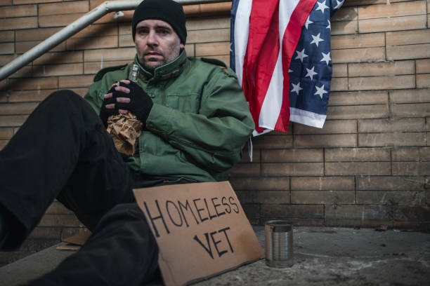 istock Homeless veteran with alcohol problem begging on the street 1308907329